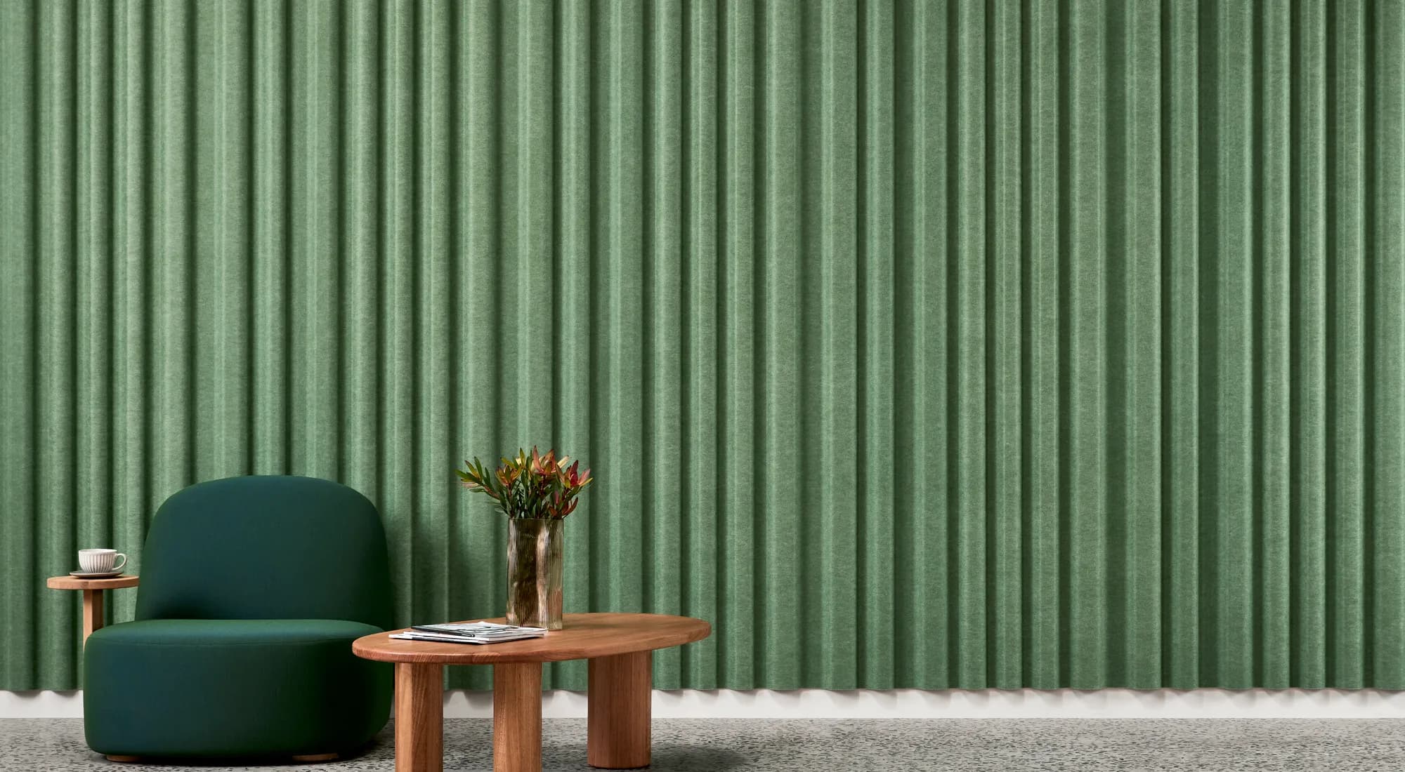 EchoPanel Curtain acoustic panels in forest green with a curved profile, shown behind a lounge setting